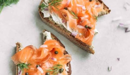 Bread rolls with smoked salmon and capers on top.