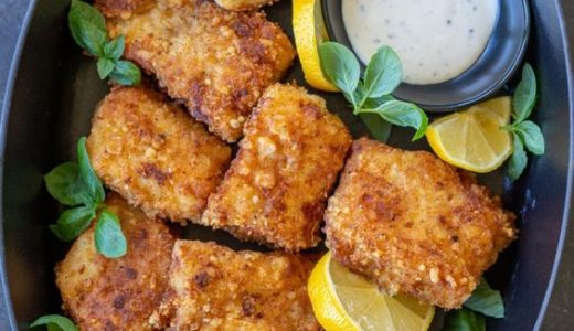 Oven-baked tender carp fries in a baking dish.