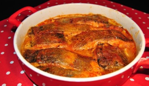 Carp on black beer in a red baking dish