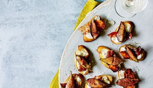 A plate full of small appetizers with fresh figs.