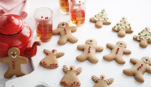 Traditional Christmas gingerbread cookies in the shape of figures and trees, decorated with colored icing.