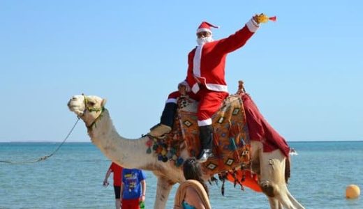 Unusual Santa on a camel in the desert.