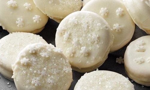 Biscuits dipped in lemon glaze decorated with sprinkles in the shape of flakes