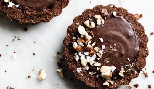 Sweet chocolate cupcakes with hazelnuts as decoration.