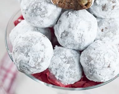 Christmas rum balls covered in icing sugar.