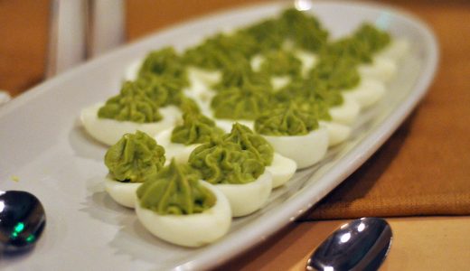 Halved eggs with avocado cream filling