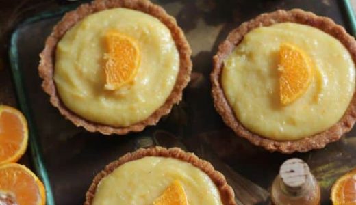 Cupcakes filled with tangerine cream and decorated with a piece of fruit.