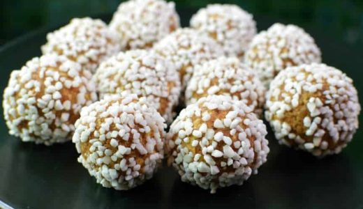 Unbaked balls of almond paste, butter, oatmeal and gingerbread covered in pearl sugar.