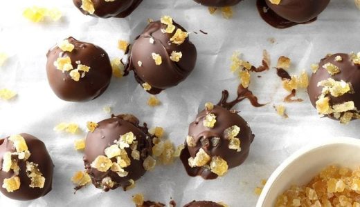 White chocolate balls wrapped in dark chocolate and decorated with candied ginger.