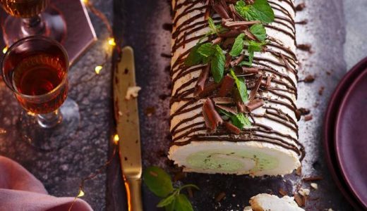 Gluten-free egg white roll with chocolate and mint with a knife next to it.