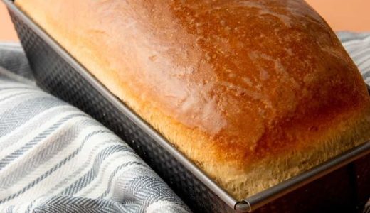 Baked bread with a golden crust in bread form.