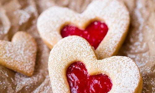 Line cookies for celiacs in the shape of hearts on baking paper