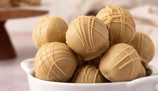 A bowl full of Lotus cookie balls covered in chocolate.