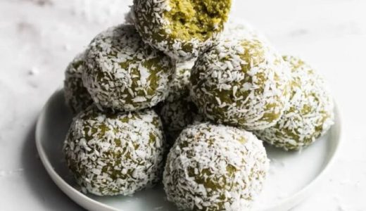 Christmas green balls wrapped in coconut on a plate.