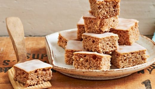 Sliced Nuremberg gingerbread on a baking sheet with lemon glaze.