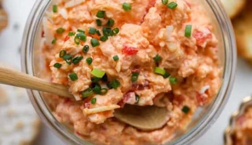 A glass full of delicious spread for sandwiches with paprika and salami.