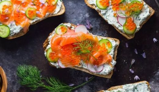 Perfectly decorated sandwiches with spread and smoked salmon.