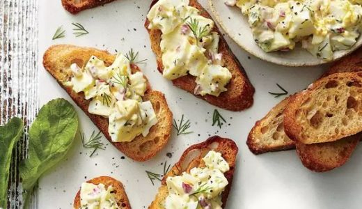 Toasted lid smeared with a creamy egg spread.