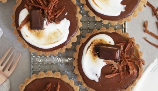 A cupcake filled with salted caramel and decorated with chocolate shavings.
