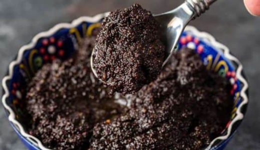 A bowl full of creamy poppy seed filling with dried fruit.