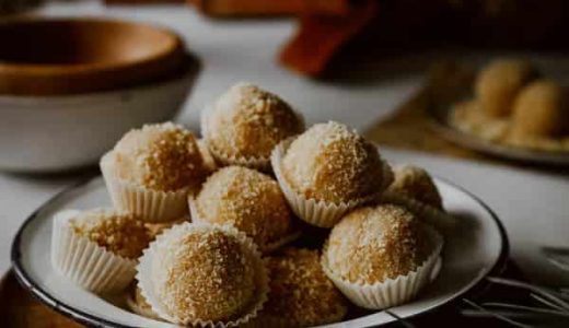 Honey balls in paper cups on a plate.