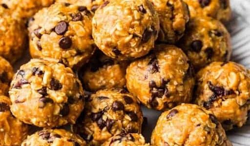 Oat balls with peanut butter, nuts, dried fruit and honey on a plate.