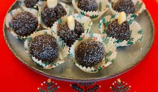 Poppy balls with almonds in paper cups.