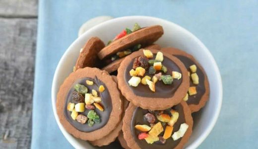 Cookies with chocolate and candied fruit in a bowl.