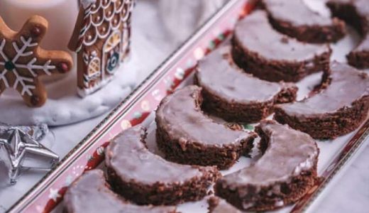 Butter rolls with chocolate and sugar coating on a tray.