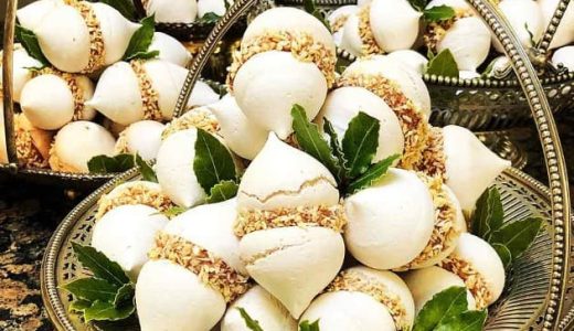 Tender meringues glued together with delicious chocolate cream and wrapped in homemade candied coconut.