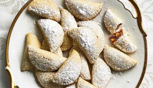 Christmas crescents filled with cherry jam, boiled grape must and candied lemon on a plate.