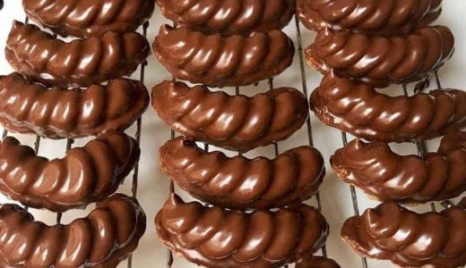 Rolls in chocolate placed on a grid.